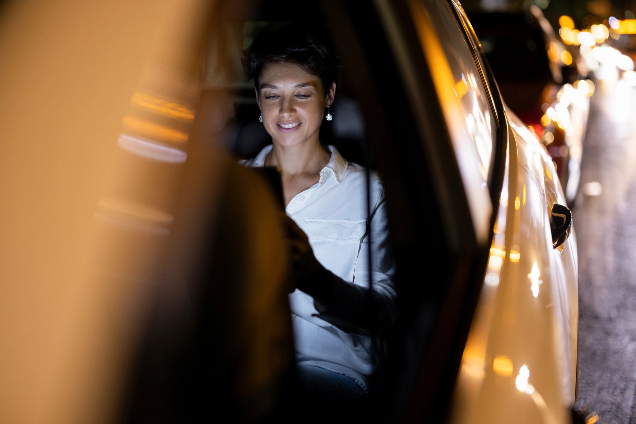 Driver using a digital tablet inside a vehicle while preparing for deliveries